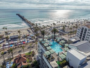 A coastal hotel with a pool, beach access, and a pier. - Steps to the Sand! Luxury Oceanside Pier Condo (Oceanside)