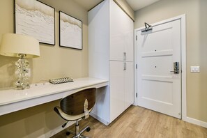 A modern office space with a desk, chair, and a white wardrobe. - Steps to the Sand! Luxury Oceanside Pier Condo (Oceanside)