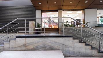 A modern interior with a staircase leading to a reception area.