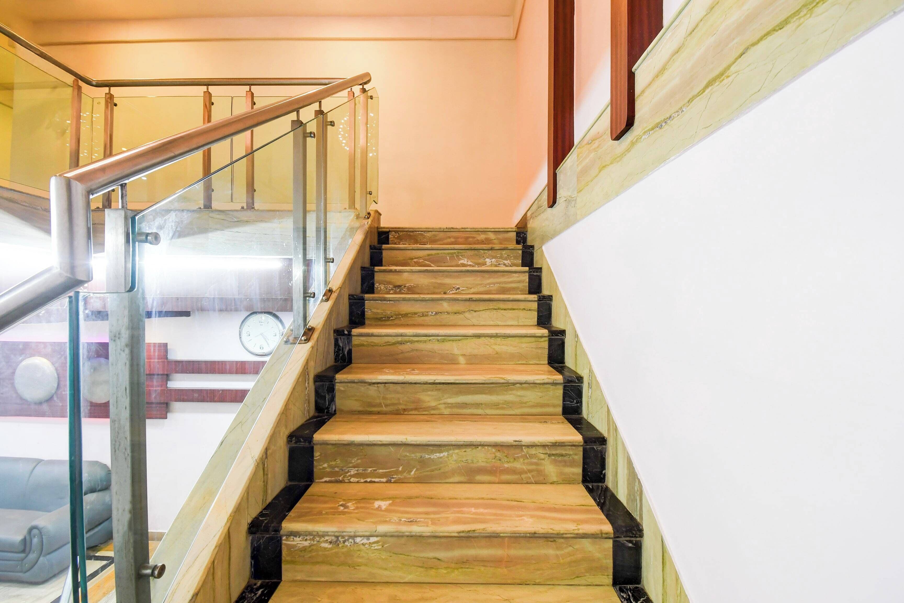 A staircase with a glass railing and wooden steps.