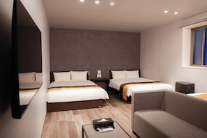 A hotel room with two beds, a sofa, a small table with a remote control, and a window with blinds. - HOTEL  GRAN M Hakata (Hakata Ward, Fukuoka City)