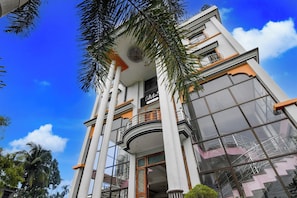A multi-story building with a balcony, large windows, and a clear sky. - Super Collection O Jalpaiguri Formerly (Jalpaiguri)