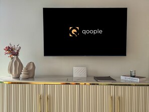 A flat-screen TV mounted on a wall displaying the Google logo. - Qoople Legend 36 В-04 100 Meter vom Strand entfernt by Interhome (Alanya)