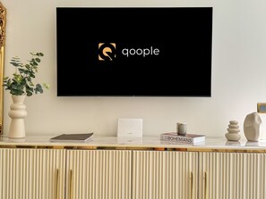 A flat-screen TV mounted on a wall displaying the Google logo. - Qoople Legend 36 В-01 100 Meter vom Strand entfernt by Interhome (Alanya)