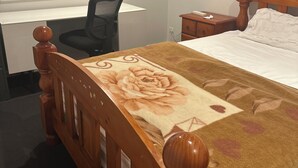 A bedroom with a wooden bed, a desk, a chair, and a window with blinds. - Room-cozy Room Rental in Caloundra West (Sunshine Coast)
