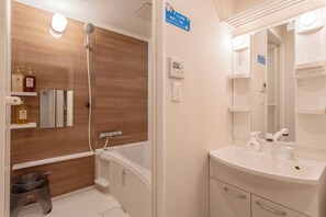 A modern bathroom with a wooden vanity, a bathtub, and a shower. - Cloud&Maple (Nishinari Ward)