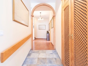 A hallway with wooden doors, a tiled floor, and framed artwork on the walls. - Tolle Villa oberhalb der Bucht Ria de Vigo by Interhome (Pontevedra)