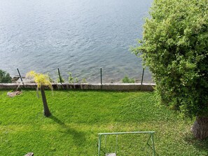 A grassy area with a swing set and a tree, overlooking a body of water. - Tolle Villa oberhalb der Bucht Ria de Vigo by Interhome (Pontevedra)