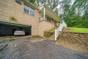 A two-story house with a garage, a staircase leading to the second floor, and a brick exterior.