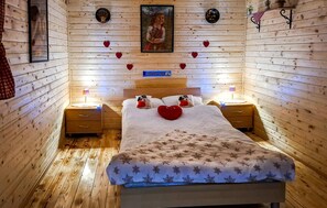 A cozy wooden room with a bed, nightstands, and decorative items. - Beautiful home in Ludbreg with sauna (Ludbreg)