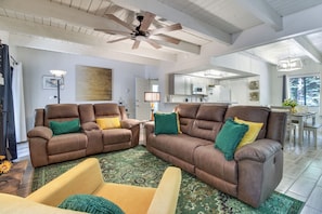 A spacious living room with two brown leather sofas, a coffee table, and a ceiling fan. - Great for Families! Pinetop Sanctuary w/ Patio (Pinetop)