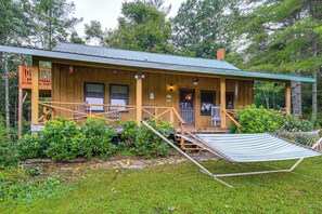 A wooden cabin with a porch, a hammock, and a small deck. - Rustic Cabin w/ Phoenix Mtn Views & Trail Access! (Lansing)