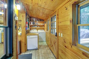 A compact laundry room with two washing machines, a drying rack, and a small sink. - Rustic Cabin w/ Phoenix Mtn Views & Trail Access! (Lansing)
