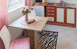 A small kitchenette with a microwave, sink, and wooden cabinets. - Awesome apartment in Hvar with house sea view (Hvar)