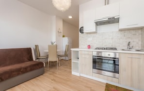 A modern kitchen with a built-in oven, a gas stove, and a white countertop. - Stunning apartment in Turanj with WiFi (Turanj)