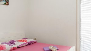 A bedroom with a bed, a pillow, and a rolled towel on a pink mattress. - Amazing apartment in Vir with WiFi (Vir)