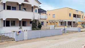 A two-story residential building with a flat roof, a balcony, and a gated entrance. - Amazing apartment in Vir with WiFi (Vir)