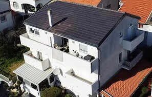 A multi-story building with a flat roof, balconies, and a visible chimney. - Stunning apartment in Biograd with WiFi (Biograd)