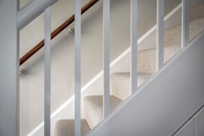 A staircase with white railings and carpeted steps. - East Lodge (Peterborough)