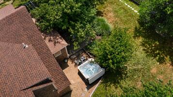 Aerial view of the private outdoor space and hot tub tucked beside the cottage.