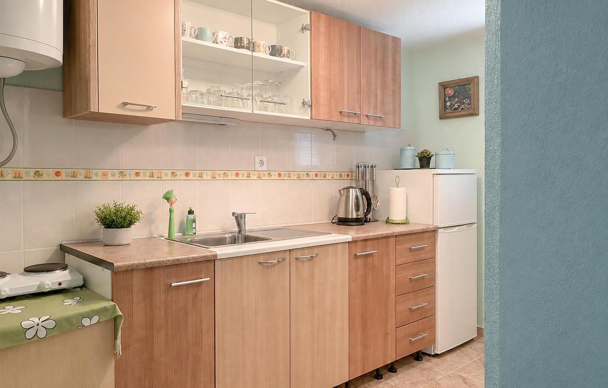Coffee/tea maker, fridge, stovetop, cookware/dishes/utensils