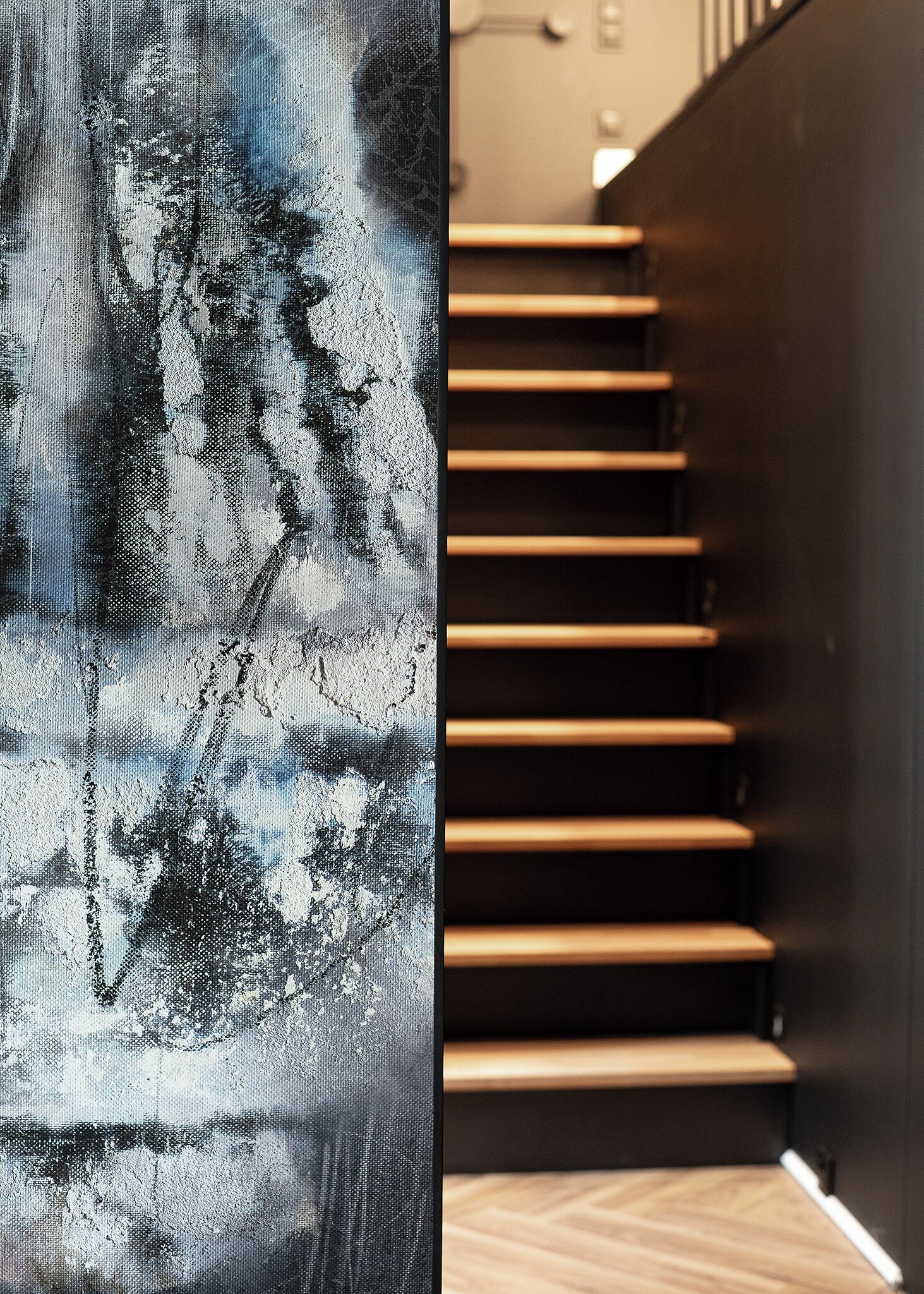 A staircase with wooden steps and a dark wall.