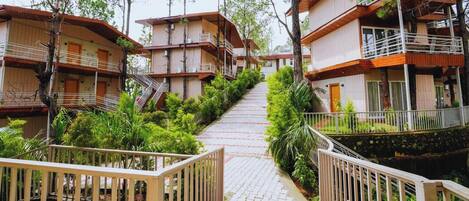 A multi-story wooden building with balconies and a central staircase.