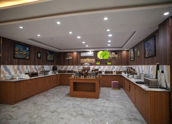 A spacious kitchen with wooden cabinets, a marble countertop, and a central island.