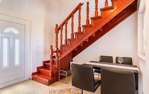 A staircase leading to a dining area with a table and chairs. - Apartment in Medulin (758) (Medulin)