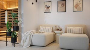 A modern living room with two sofas, a coffee table, and a bookshelf. - Stunning home in Zupanici with sauna (Zupanici)