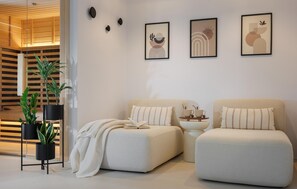 A modern living room with two sofas, a coffee table, and a bookshelf. - Stunning home in Zupanici with sauna (Zupanici)