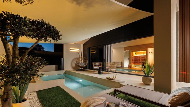 A modern outdoor pool area with a seating arrangement and a large tree. - Stunning home in Zupanici with sauna (Zupanici)