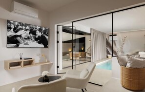 A modern living room with a television, a pool, and a glass door leading to an outdoor seating area. - Stunning home in Zupanici with sauna (Zupanici)