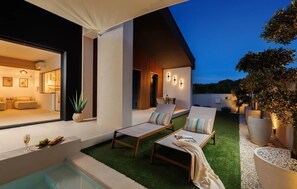 A modern outdoor living area with a pool, lounge chairs, and a dining table. - Stunning home in Zupanici with sauna (Zupanici)