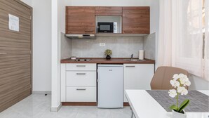 A compact kitchen with a microwave, a small refrigerator, and a sink. - Nice apartment in Pula with WiFi (Pula)