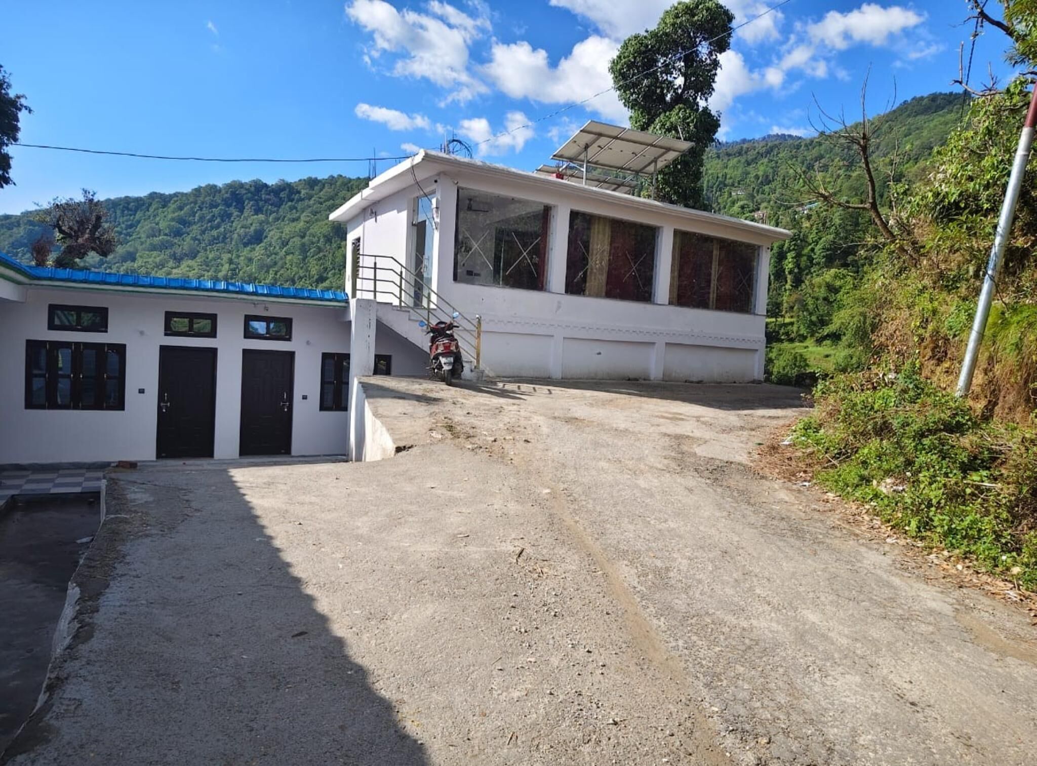 A building with a covered entrance and a motorcycle parked in front.