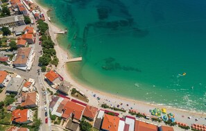 An aerial view of a coastal town with a beach, buildings, and a pier. - Awesome apartment in Baska with WiFi (Baska)