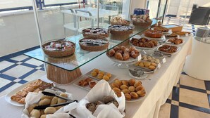 A buffet table with various baked goods and pastries. - Damavi Hotel (San Foca)