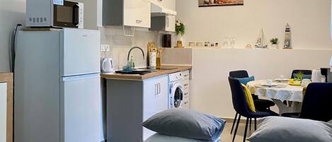 Coffee/tea maker, fridge, stovetop, cookware/dishes/utensils