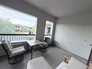 A balcony with a table, chairs, and a sofa. - Cozy 3-bedroom condo with AC in awesome Cave Creek AZ (Cave Creek)