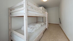 A bunk bed with a mattress and pillows, a door, and a light fixture on the ceiling. - Apartment on the coast for 6 people (MIDDELKERKE)