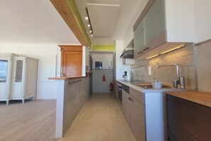 A modern kitchen with a built-in oven, a coffee machine, and a sink. - Apartment with Panoramic Sea Views (MIDDELKERKE)