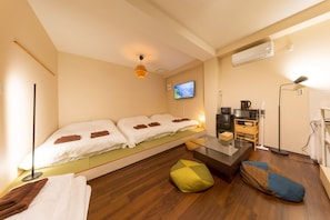 A modern hotel room with a bed, a TV, a coffee machine, and a desk. - Fukurouan (Toshimaku Kamiikebukuro)