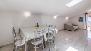 A dining area with a table and chairs, a fruit bowl, and a sofa in a bright room with a skylight. - Cozy home in Trogir with private swimming pool, can be inside or outside (Trogir)