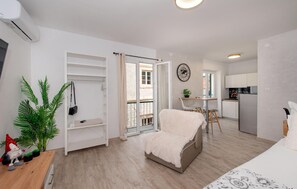 Um apartamento moderno com varanda, área de refeições e cozinha.