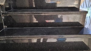 A set of black marble stairs with a handrail on the right side. - Hotel CS Inn & Restaurant (Agra)