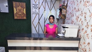 A reception desk with a check-in/out sign, a telephone, and a printer. - Hotel CS Inn & Restaurant (Agra)