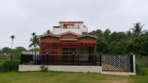 A two-story building with a sign reading 'Asuss International Resort'. - Asusss International (Kanthi)