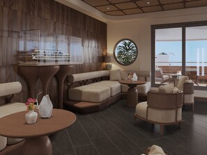 A modern lounge area with a wooden wall, a round table with a ship model, a sofa, and a view of the outdoors. - Harmony Boutique Cruise (Tuan Chau)