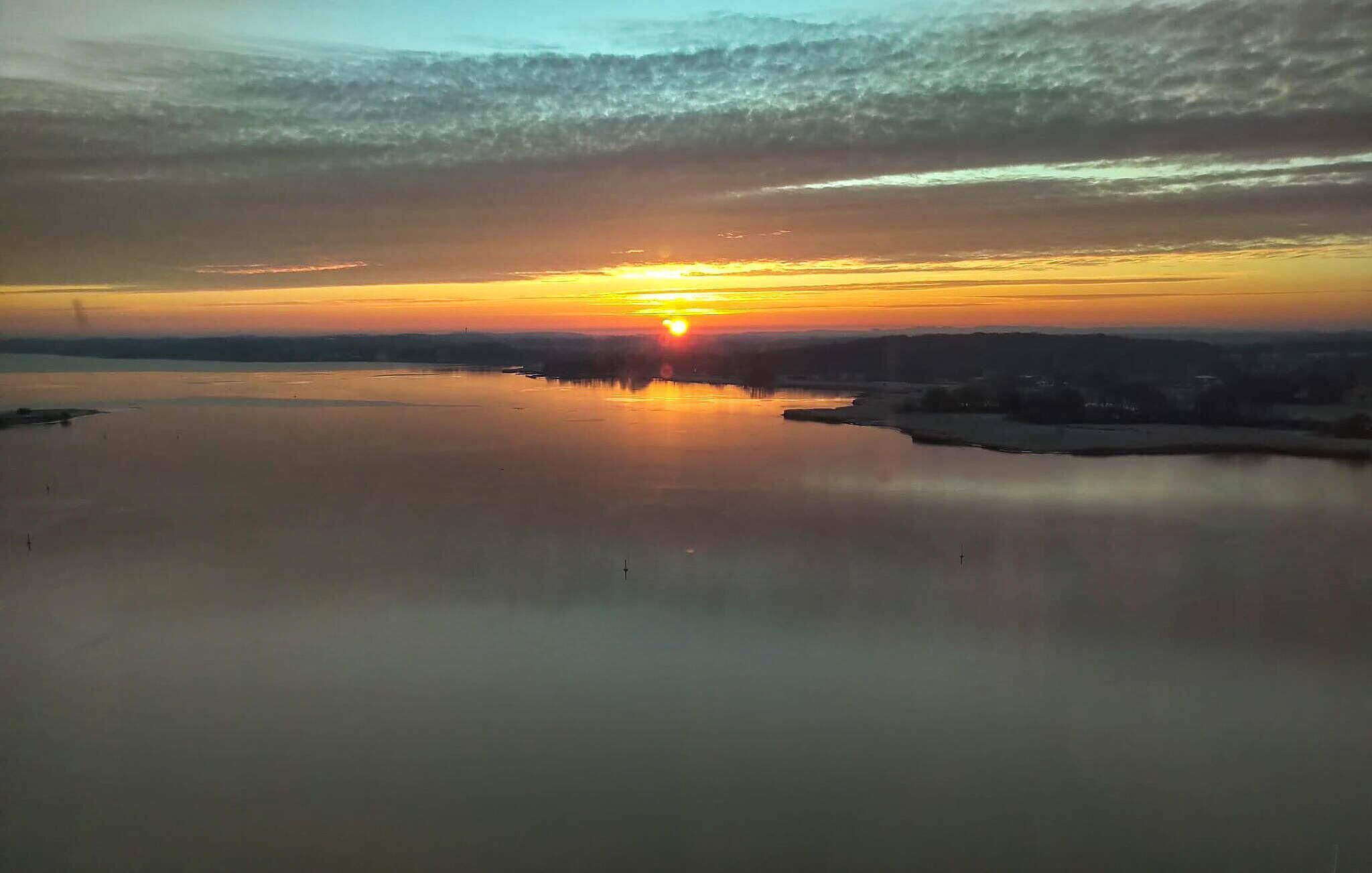 A calm body of water reflecting the sunset.